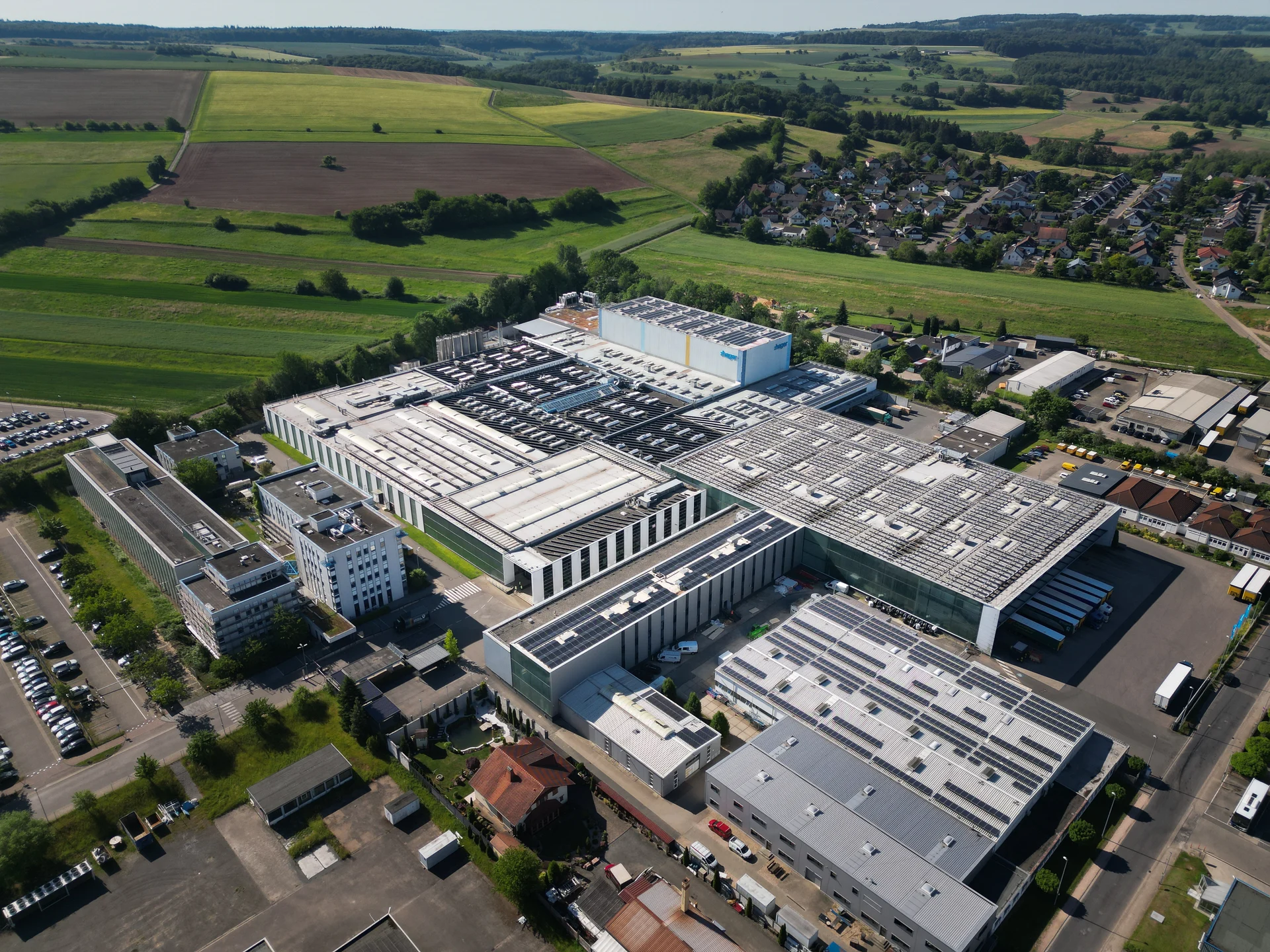 Luftaufnahme des Hager-Werks zwischen Feldern und Ortschaften